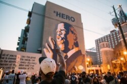 Mourners of the late Rep. John Lewis, a pioneer of the civil rights movement and long-time member of the U.S. House of Representatives, hold a vigil in his memory in Atlanta, Georgia, July 19, 2020.