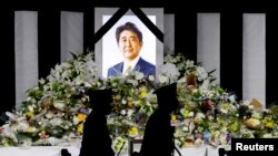 Flower tributes are left outside Nippon Budokan Hall, where the state funeral for former Prime Minister Shinzo Abe was held, in Tokyo, Japan September 27, 2022. 