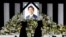 Flower tributes are left outside Nippon Budokan Hall, where the state funeral for former Prime Minister Shinzo Abe was held, in Tokyo, Japan September 27, 2022. 