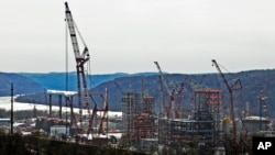 FILE - This April 18, 2019 file photo shows part of a petrochemical plant being built on the banks of the Ohio River in Monaca, Pa., for the Royal Dutch Shell company.