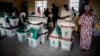 Electoral commission officials check voting material at a polling station set up in the Shagari Day Secondary School in Yola, in Nigeria's Adamawa State, Feb. 22, 2019, on the eve of general elections.