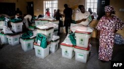 Electoral commission officials check voting material at a polling station set up in the Shagari Day Secondary School in Yola, in Nigeria's Adamawa State, Feb. 22, 2019, on the eve of general elections.