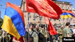 People attend a meeting to recruit military volunteers after Armenian authorities declared martial law and mobilised its male population following clashes with Azerbaijan over the breakaway Nagorno-Karabakh region in Yerevan, Armenia, Sept. 27, 2020.