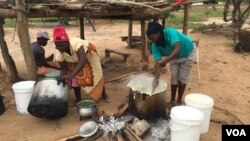 A family in Chachacha village in Chipinge prepares Zimbabwe’s popular, thick porridge called sadza made of corn meal and served with relish, March 2016. Most households eat sadza twice a day, at lunch and dinner. But as the country’s hunger worsens, the s