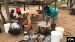 A family in Chachacha village in Chipinge prepares Zimbabwe’s popular, thick porridge called sadza made of corn meal and served with relish, March 2016. Most households eat sadza twice a day, at lunch and dinner. But as the country’s hunger worsens, the staple food might soon become a delicacy. (S. Mhofu/VOA)