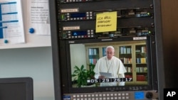 Pope Francis is seen on a video screen at U.N. headquarters as he speaks in a pre-recorded message addressing the 75th session of the General Assembly, Sept. 25, 2020. 