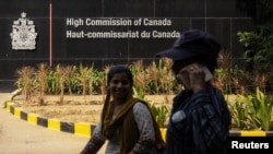 FILE - Women locomotion  past   the main   gross  of the Canadian High Commission, successful  New Delhi, Oct. 17, 2024.