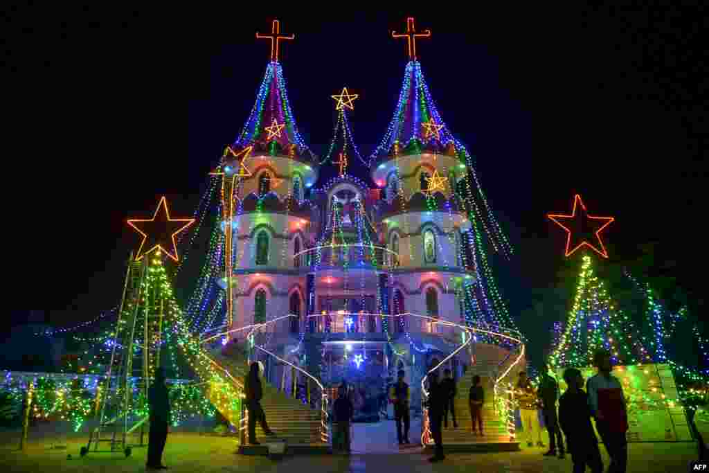 Indian Christians pay their respects at the illuminated St. Mary&#39;s Catholic Church in Amritsar, India.