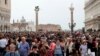 FILE - Tourists are seen at St. Mark's Square in Venice, Italy, April 15, 2018.