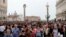 FILE - Tourists are seen at St. Mark's Square in Venice, Italy, April 15, 2018.