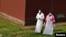 Ugandan medical staff inspect the Ebola preparedness facilities at the Bwera general hospital near the border with the Democratic Republic of Congo in Bwera, Uganda, June 12, 2019. 