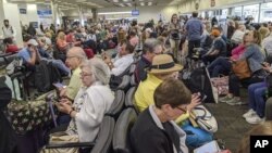 People waiting screening at a United States airport.