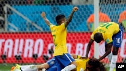 Brazil players celebrate after scoring a third goal during the group A World Cup soccer match against Croatia in the opening game of the tournament at Itaquerao Stadium in Sao Paulo, Brazil, June 12, 2014. 