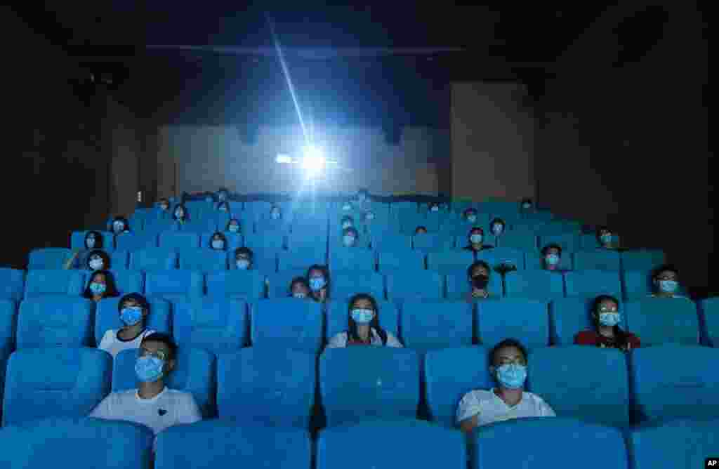 Movie-goers are spaced apart as they watch a movie in a newly reopened cinema in Hangzhou in eastern China&#39;s Zhejiang province.
