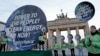 Greenpeace activists protest in front of the Brandenburg Gate in Berlin, Germany, April 13, 2014.