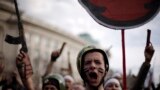 Protesting students wearing fake military uniforms shout anti-government slogans during a demonstration in front of Sofia University. Thousands of Bulgarians joined several separate rallies against rampant corruption, low incomes and high unemployment in the European Union&#39;s poorest country, mounting pressure on the Socialist-led government.