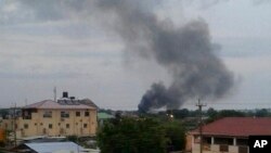 FILE - Black smoke rises above Juba, South Sudan, July 10, 2016. Explosions and heavy weapons gunfire shook the city as government and opposition forces clashed.