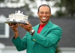 FILE - Tiger Woods celebrates after winning the 2019 Masters, at Augusta National Golf Club in Augusta, Georgia, April 14, 2019.