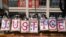 People hold placards to form the word "Justice" during a protest against the military coup in Yangon, Myanmar, Feb. 22, 2021. 