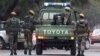 Zimbabwean soldiers who are thought to be escorting President Robert Mugabe leave a private hospital in Harare, Zimbabwe, on Thursday, June, 16, 2011. (AP Photo/Tsvangirayi Mukwazhi)