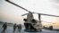FILE - U.S. soldiers from the 3rd Cavalry Regiment load into a CH-47 Chinook helicopter for an advising mission to an Afghan National Army base at forward operating base Fenty in the Nangarhar province of Afghanistan, Dec. 21, 2014. 