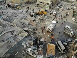 A drone picture taken Jan. 15, 2020, shows members of the Syrian Civil Defence, also known as the White Helmets, searching through the rubble of a building at the site of a regime airstrike on Syria's last major opposition bastion of Idlib.