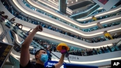 Demonstrators sing a theme song written by protesters "Glory to Hong Kong" at the Times Square shopping mall in Hong Kong, Sept. 12, 2019. 