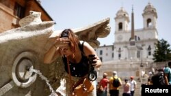 A woman cools off at Fontana della Barcaccia at the Spanish Steps during a heat wave in Rome, Italy July 17, 2023. 