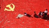 Students use red scarves to make a flag of the Communist Party of China, ahead of the 19th National Congress of the Communist Party, at a primary school in Linyi, Shandong province, China September 13, 2017. 