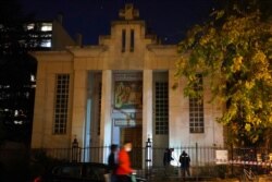 Police search for clues after a priest was shot, Oct.31, 2020, in Lyon, France. A Greek Orthodox priest was shot while he was closing his church.