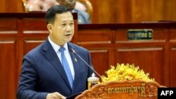 This handout from the Cambodia National Assembly taken and released on August 22, 2023 shows Cambodia's Prime Minister Hun Manet delivering a speech during a parliamentary meeting at the National Assembly building.