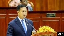 This handout from the Cambodia National Assembly taken and released on August 22, 2023 shows Cambodia's Prime Minister Hun Manet delivering a speech during a parliamentary meeting at the National Assembly building. (Photo by Handout / AFP)