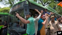 Activists of the youth wing of India's ruling party Bharatiya Janata Party shout slogans as they are detained during a protest against the slaughter of a calf by Congress party's youth wing members, in New Delhi, May 30, 2017.