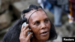 FILE - A woman makes a call on her mobile phone in Ethiopia's capital, Addis Ababa, Nov. 9, 2015.