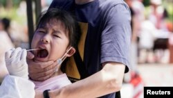 중국 우한에서 어린이를 상대로 코로나바이러스 검사 중인 의료진 (자료사진) 
