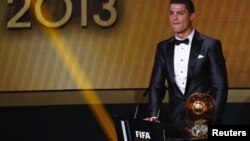 Cristiano Ronaldo reacts after being awarded the FIFA Ballon d'Or 2013 in Zurich January 13, 2014. Portugal and Real Madrid forward Cristiano Ronaldo was named the world's best footballer for the second time on Monday, preventing his great rival Lionel Me