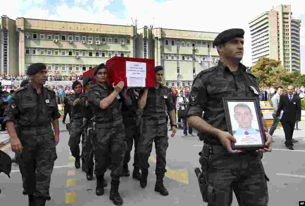 Turkish police officers carry the coffin of Turkish police special operations officer Sahin Polat Aydin, one of the four officers killed Monday in a landmine attack attributed to militants of the Kurdistan Workers&#39; Party, or PKK, in Silopi, southeastern Turkey,&nbsp;during a ceremony in Ankara, Aug. 11, 2015.