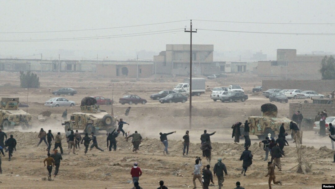 FILE: Protesters throw stones at Iraqi security forces during an anti-government demonstration in Falluja, Iraq, January 25, 2013.