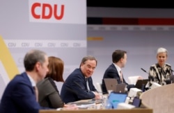 Newly elected Christian Democratic Union leader Armin Laschet, center, is pictured with delegates following his election during the second day of the party's 33rd congress in Berlin, Germany, Jan. 16, 2021.