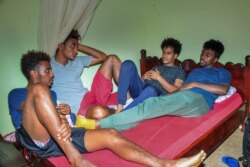 Eritrean under-20 soccer players Hermon Fessehaye Yohannes, Simon Asmelash Mekonen, Hanibal Girmay Tekle, and Mewael Tesfai Yosief talk together in a house where they are staying in Uganda.