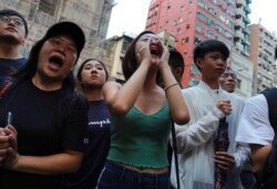 Demonstrators shout slogans during a protest in Hong Kong, Oct. 12, 2019.