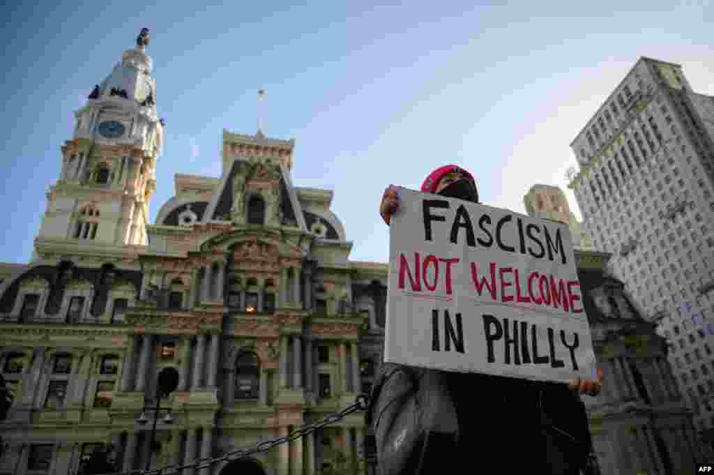 A woman holds a placard denouncing the U.S. presidential election results, outside City Hall in Philadelphia, Pennsylvania, on Nov. 6, 2024. 