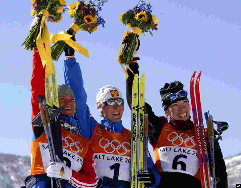 A partir de la gauche, le médaillé d'argent de Larissa Lazutina, de la Russie, le médaillé d'or Olga Danilova, de la Russie, et le médaillé de bronze Beckie Scott, du Canada, célébrent leur victoire en ski de 5 km de la course féminine aux Jeux olympiques d'hiver de vendredi 15 février 