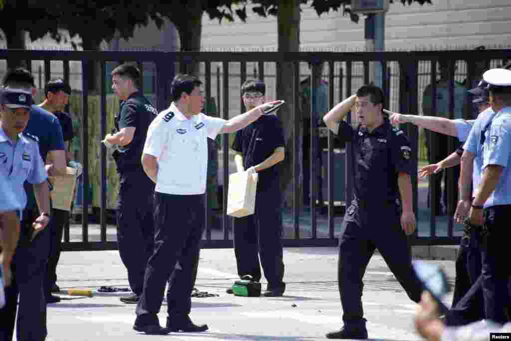 在美国驻北京大使馆外爆炸地点附近的中国警察。（2018年7月26日）