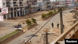 FILE - Soldiers clear a road in Bamenda, Cameroon, December 2016.