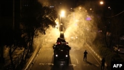 Iranian firefighters disinfect streets and alleys in southern Tehran to halt the wild spread of coronavirus on March 11, 2020