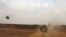 A helicopter of the French army escorting a vehicle transporting Mali's Prime Minister Moussa Mara from Gao to Kidal, May 17, 2014.
