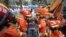 Rescue workers move a casualty at the site of a hotel being used for the coronavirus quarantine collapsed, in the southeast Chinese port city of Quanzhou, Fujian province, China, March 8, 2020.