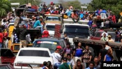 Venezuelans line up to cross into Colombia at the border in Paraguachon, Colombia February 16, 2018.