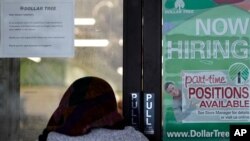 A shopper enters a retail store as a hiring sign shows in Buffalo Grove, Ill., Thursday, June 24, 2021. America’s employers added 850,000 jobs in June, well above the average of the previous three months and a sign that companies may be having an easier…